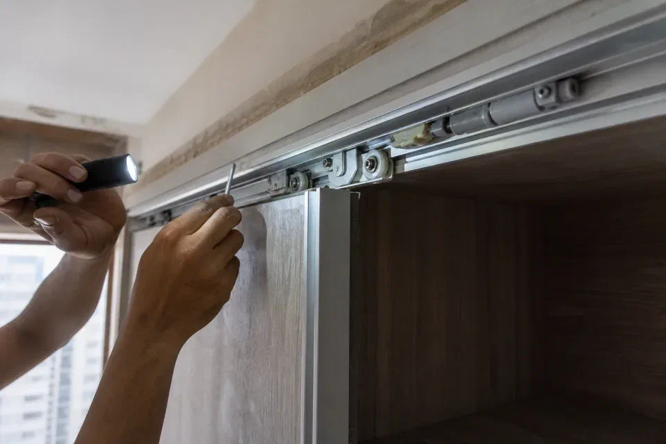 Illustrative sliding wardrobe top track roller and bottom guide inspection in Gurugram